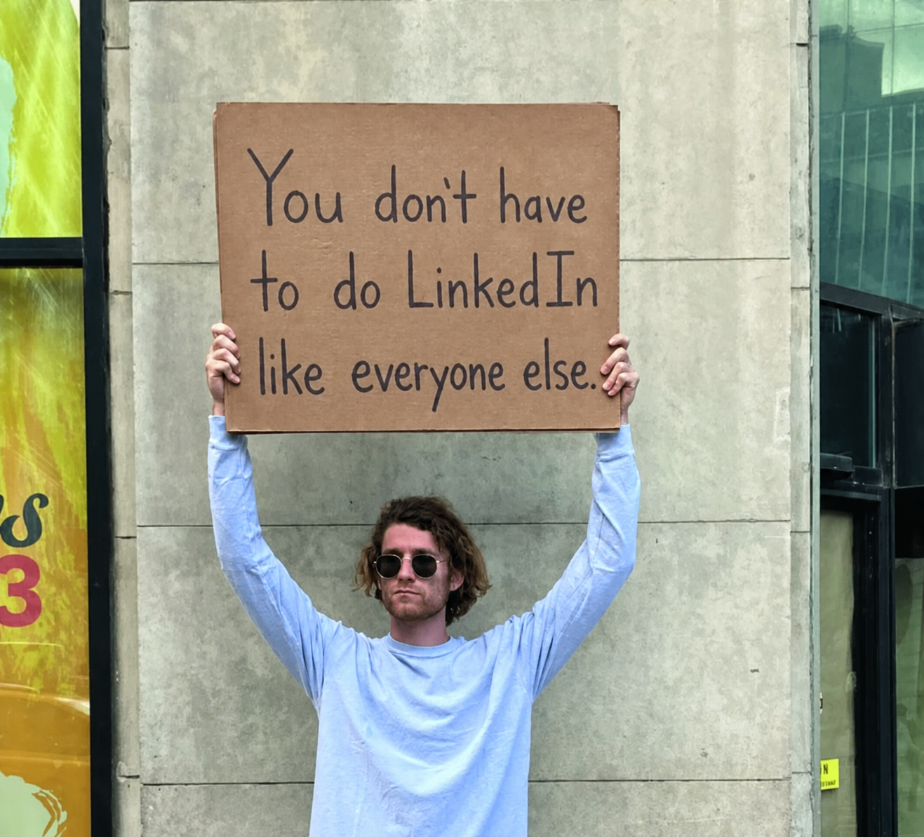 Person holding a cardboard sign that reads 'I still don't know what crypto is'